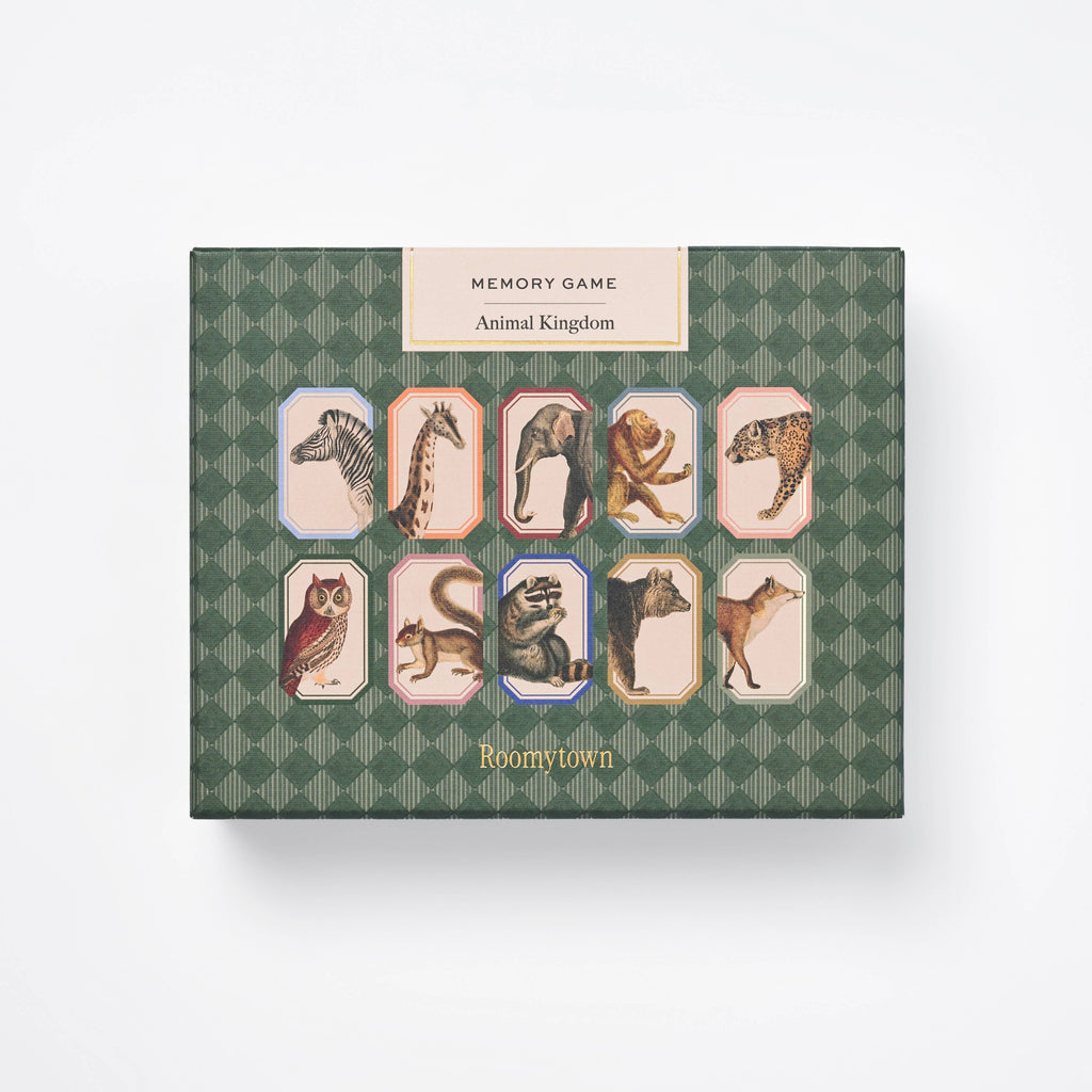 A green patterned box labeled "Memory Game - Animal Kingdom" features vintage animal illustrations—zebra, giraffe, lion, cheetah, owl, monkey, and bear—in a grid layout, emphasizing this classic matching game.