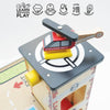 A wooden toy emergency helicopter rests on the Fire & Rescue Garage playset’s helipad. Above are icons that read: "LEARN DISCOVER PLAY," "IMAGINATION," "COORDINATION," "DEXTERITY," "CAUSE & EFFECT," and "CREATIVITY.
