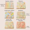 The ABC Learning Blocks (ships in one week) set features seven colorful grids with wooden blocks showing capital and lowercase letters, phonics, numbers, math symbols, illustrated objects, text labels, dice faces, symbols, and blanks for toddler learning.