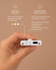 A hand holds a small electronic device with a USB-C port and buttons for light color selection and power/sensor activation, shown with descriptive text on a beige background—perfect for illuminating every room in your Fully Furnished Dollhouse With Lights, House of New York - The Six-Storey Giant.