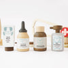 Four toy bottles from the Pretend Play Animal Vet Set—paw balm, ear drops, medicine, and pet shampoo—feature pastel colors and cute animal designs on white, inspiring career role play fun for young vets.