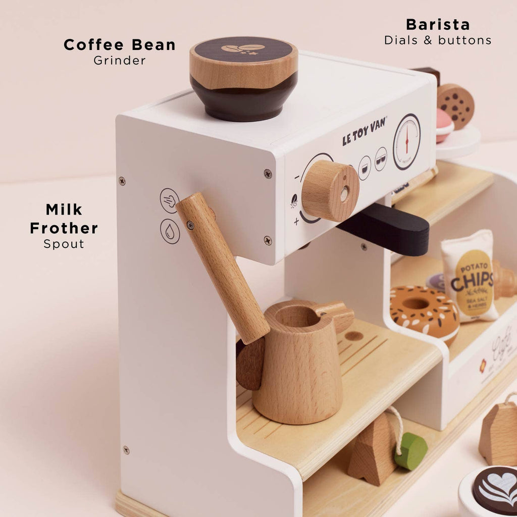 The Barista Café Shop is a wooden coffee machine toy with a bean grinder, barista dials, and frother spout. This playset includes a cup, jug, and pastries—ideal for pretend café play in any playroom. Ships in one week.