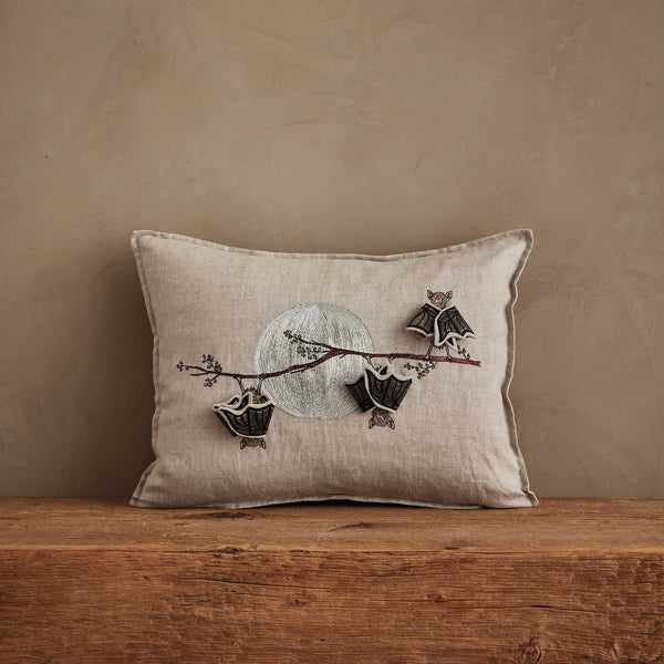 The Coral & Tusk Bat Branch Pillow, featuring embroidered baby bats on a branch before a silver moon, adds a whimsical touch—perfect for your Halloween display. Ships in one week.