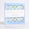 Scrabble Bianco Edition board game box featuring a blue and white deluxe game board design with premium lettering and product details printed on the front.