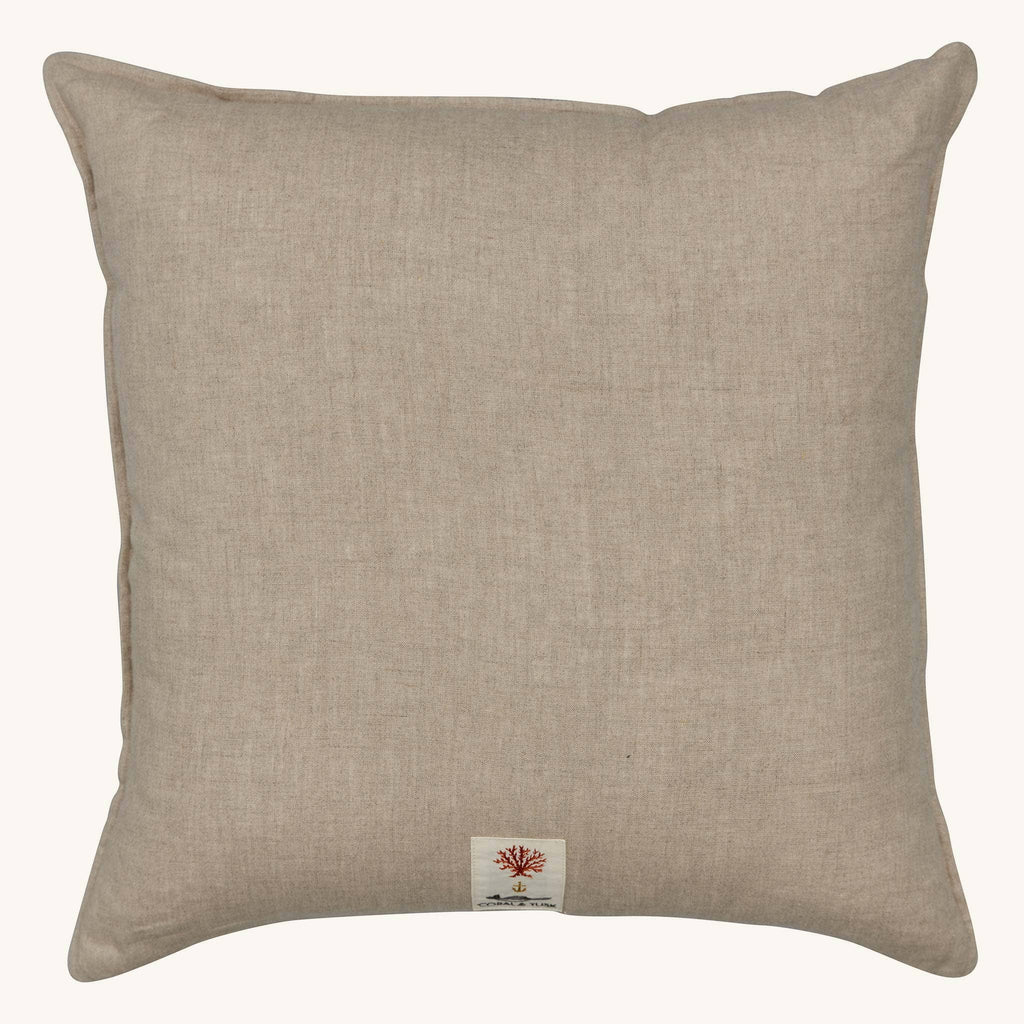 Square light brown embroidered Coral & Tusk Christmas Cheer Wreath Pillow with a small branded patch featuring a coral icon at the bottom center.