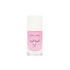 A bottle of pink Nailmatic water-based nail polish with a cute, smiling face design on the front, featuring closed eyes with long eyelashes, set against a plain white background.