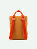 A Sticky Lemon Backpack Large in Farmhouse color with bold orange straps and recycled RPET buckle details, displayed against a plain white background.