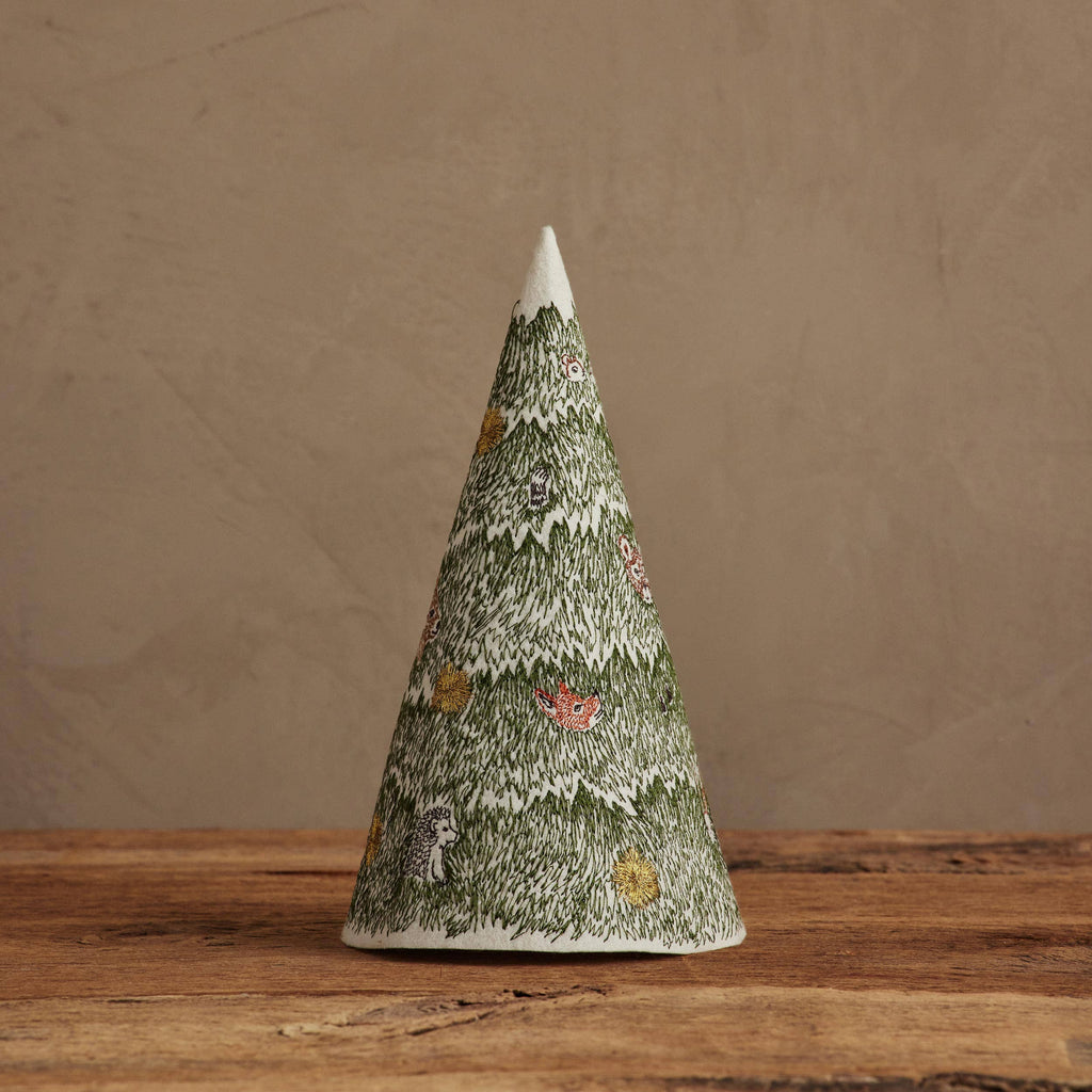 A cone-shaped Coral & Tusk Peek a Tree Tree ornament featuring embroidered forest animals and flowers hidden in green evergreen branches.