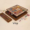 The 3-in-1 Game Collection features Monopoly, Sorry, and Mancala with pieces, cards, and tokens neatly arranged around the board on a cream-colored surface.