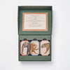 An open green box contains the Memory Game - Animal Kingdom with vintage animal illustrations (elephant, lion, leopard) on top. A card with game instructions is printed inside the lid.