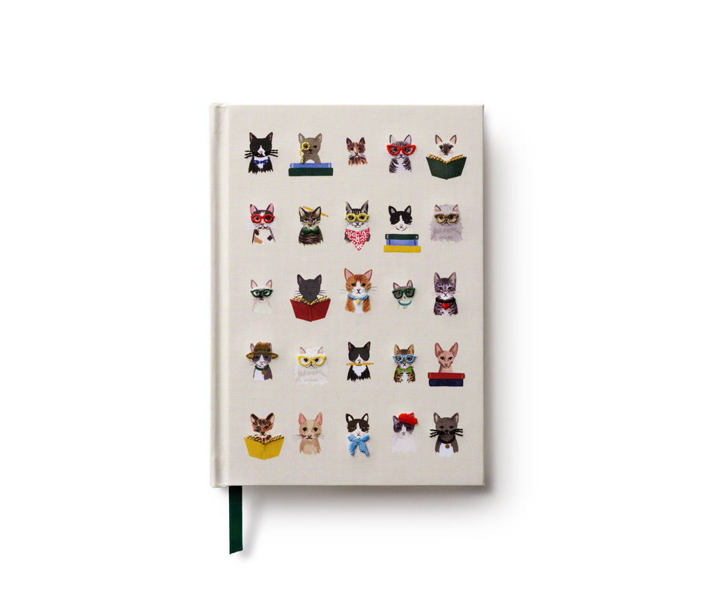The Studious Cats Embroidered Journal features a white cover with embroidered cats in five rows, each sporting unique accessories like glasses, bow ties, scarves, or books—an ideal gift for any cat lover.