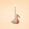 A lit Flamingo Cake Topper - Final Sale (ships in one week) featuring a pink flamingo with a blue and yellow party hat makes a charming handcrafted keepsake against the plain beige background.
