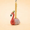 The Flamingo Cake Topper - Final Sale (ships in one week) features a ceramic flamingo with a yellow polka-dot hat and candle, making it an ideal handcrafted collectible or birthday gift.