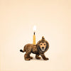 The Lion Cake Topper - Final Sale (ships in one week) is a handcrafted figurine featuring a party hat and candle, perfect as a charming birthday keepsake set against a beige background.