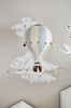 A handmade Hot Air Balloon - Beige / Mint / Grey model hangs against a wall with illustrated clouds, birds, and stars, creating a dreamy and whimsical decoration for children’s rooms.