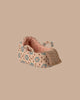 A small, fabric baby shoe with pink and beige tones, blue and brown florals, and lace detail—perfect for the PRE-ORDER: Carry Cot, Baby Mouse Size - Rose (ships late November)—displayed on a plain beige background.