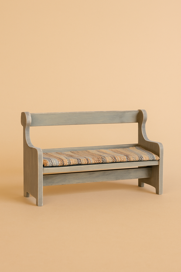 The Maileg Mouse Bench - Off-White is a small hand-painted vintage-style wooden bench with a simple backrest, curved armrests, and a plaid cushioned seat—perfect mouse furniture against a beige background.