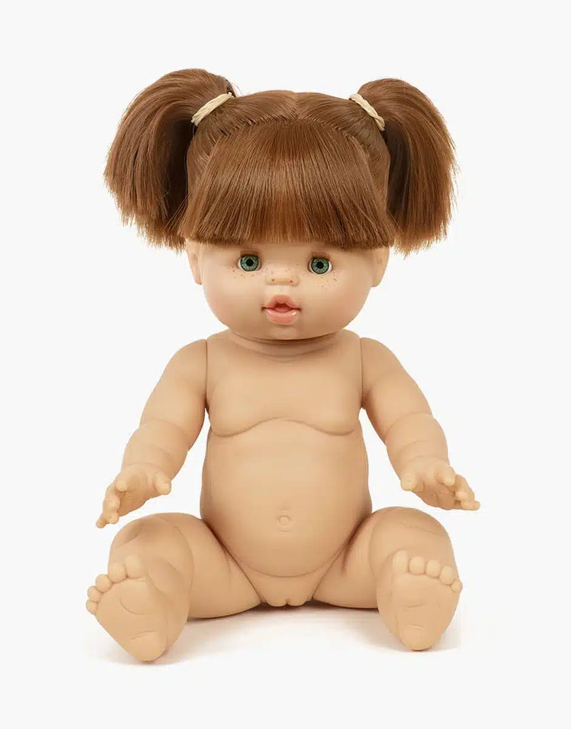 The Minikane Baby Doll (13") - Gabrielle features a realistic, anatomically correct design with light skin, green eyes, and brown hair in two ponytails. Shown unclothed and upright against a white background. Clothing sold separately.