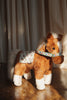 A soft Konges Sloejd Fiona Horse toy with a brown coat, white markings, and a floral patterned saddle and bridle.