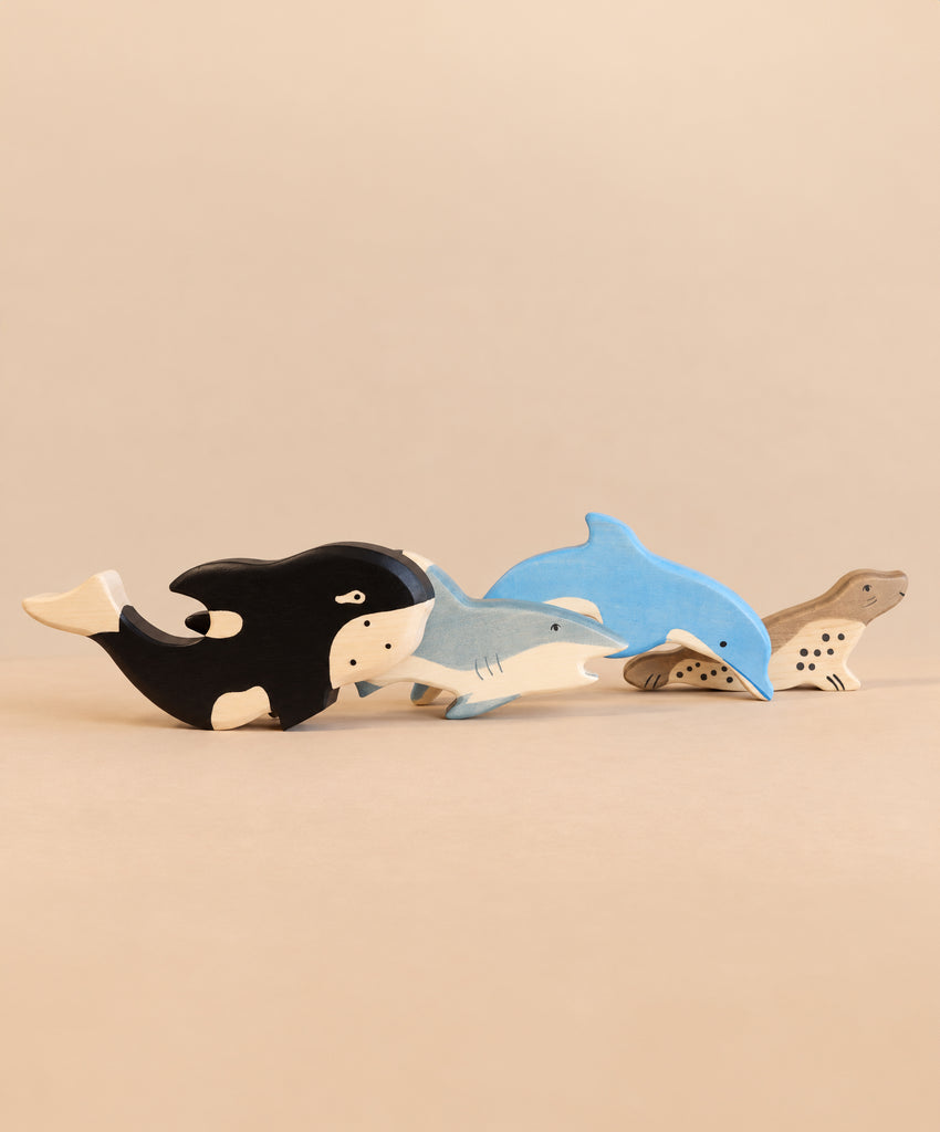 Holztiger Handmade Wooden Ocean Animals Set featuring four handcrafted figures of a killer whale, shark, dolphin, and seal.