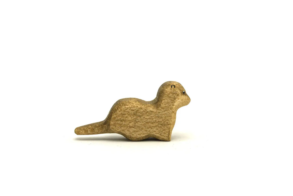 Handmade Holzwald Small Otter figurine crafted from wood in a resting position as a sustainable toy.