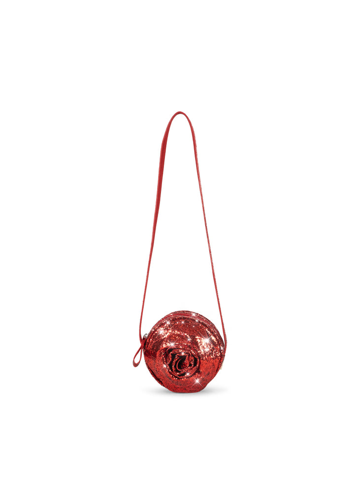 A round, glittery red Konges Sloejd Rose Shoulder Bag with a slim shoulder strap and zipper closure.