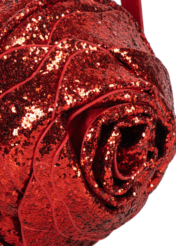 A glittery red Konges Sloejd Rose Shoulder Bag with a slim strap and zipper closure.