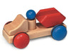 The Fagus Wooden Skip Truck - Mini Series is a natural wood construction truck toy with red and blue wheels, a removable peg driver, and a red skip container on its body.