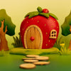 The Bumbu Handmade Wooden Strawberry House, shaped like a strawberry with charming details, ships in one week and is an ideal Montessori toy for imaginative play on a bright, colorful background.
