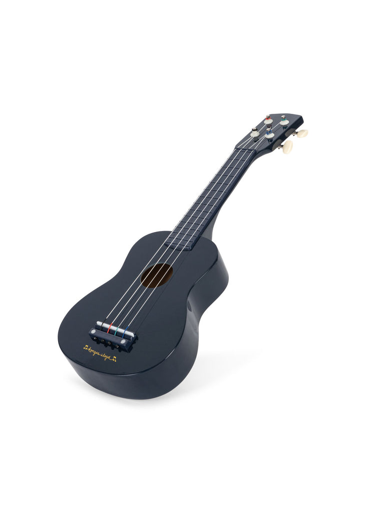 The Konges Sloejd Wooden Ukulele - Midnight is a small, dark blue wooden ukulele with 4 strings and white tuning pegs, shown on a white background.