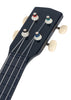 Close-up of the Konges Sloejd Wooden Ukulele - Midnight: FSC-certified dark blue headstock with four white tuning pegs, colored string windings, and part of the fretboard with its 4 strings.