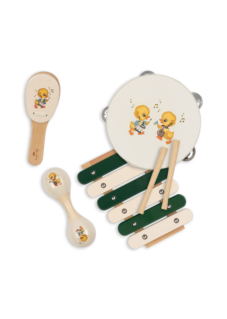 The Konges Sloejd Music Set - Green is a delightful kids’ instrument set with wooden musical toys—a maraca, xylophone, tambourine, and castanet—each decorated with playful yellow duckling music-themed illustrations.