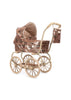 Konges Sloejd Mini Doll Pram - Sparkly Cherry Sequin, a foldable doll pram covered in rose gold sequins with a cherry pattern and a matching small bag hanging from the handle.