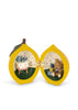 A lemon-shaped Konges Sloejd Mini Surprise House - Lemon that opens to reveal an imaginative miniature world: a table set for tea on one side and a teddy bear with gifts on the other.