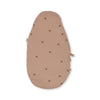 The Konges Sloejd Doll Sleeping Bag in Cherry Blush is a light brown, oval-shaped lounger made from organic cotton with cherry prints. It has subtle side ties, a soft padded texture with recycled polyester filling, and is shown on a white background.