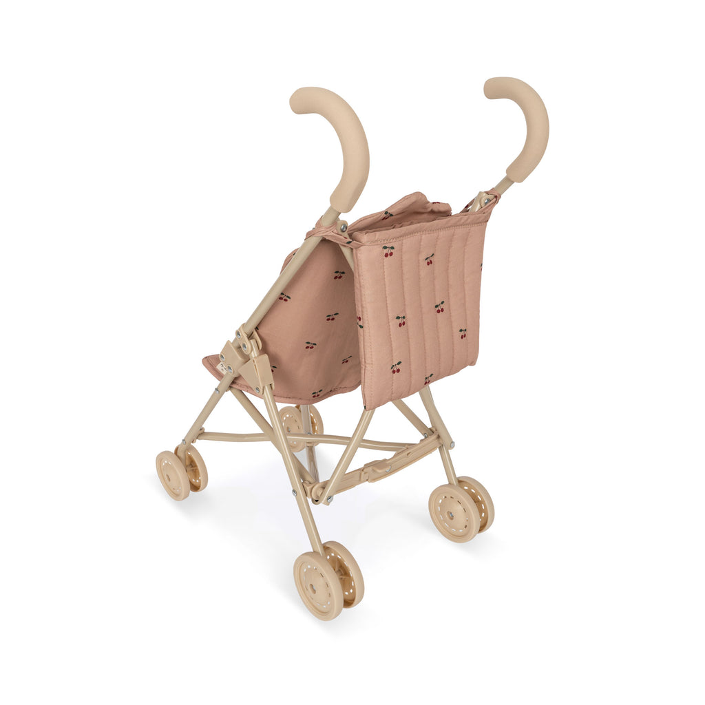 Konges Sloejd Doll Stroller - Cherry Blush in dusty pink with a small red cherry print, featuring a beige frame, double wheels, and handles.