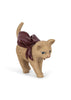 A small, tan toy kitten wearing a large, dark red bow on its back, featured as a Konges Sloejd Christmas Door accessory.