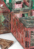 Translucent pink and green glitter-filled magnetic tiles from the Konges Sloejd Piece By Piece Magentic Building Set, connected to form geometric shapes for an engaging educational activity.