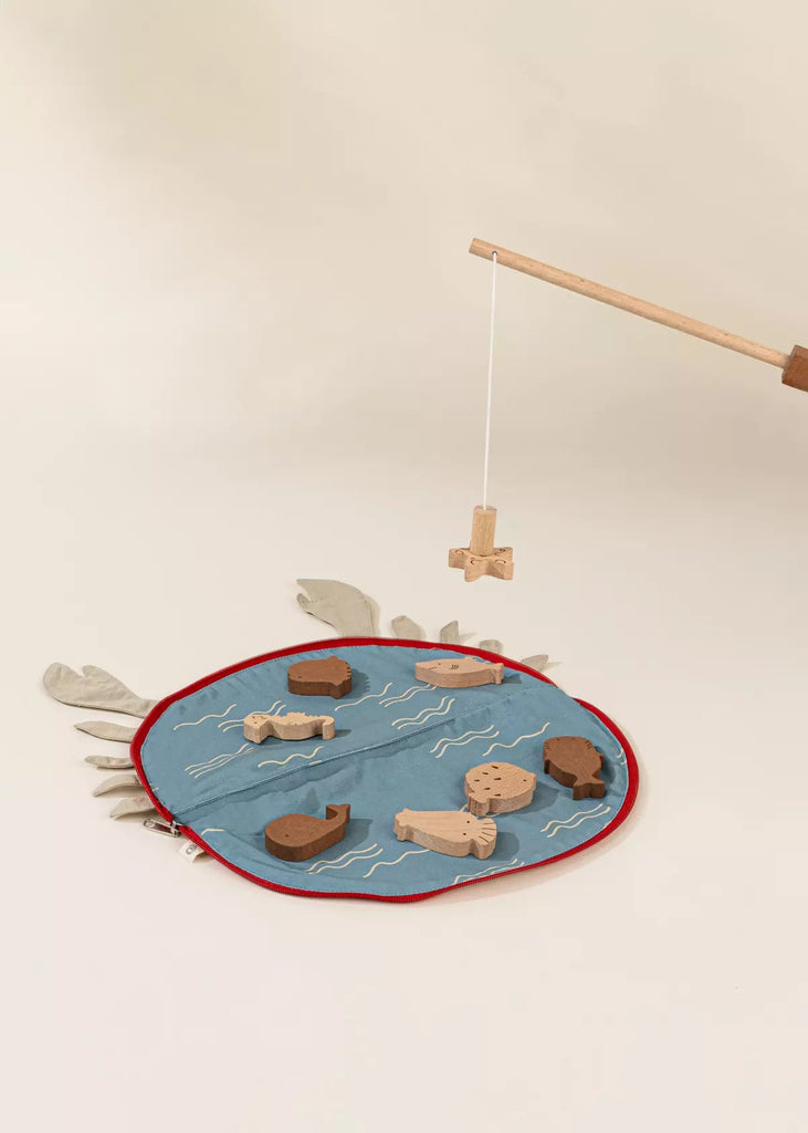 The Wooden Fishing Game with Bag includes a blue circular water-themed mat, wooden fish and sea creatures, plus a fishing rod with string and hook—perfect for an engaging fishing adventure that boosts cognitive development.