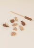 The Wooden Fishing Game with Bag includes a rod, string, and sea animal pieces like a whale, fish, and octopus—ideal for encouraging cognitive development through play.
