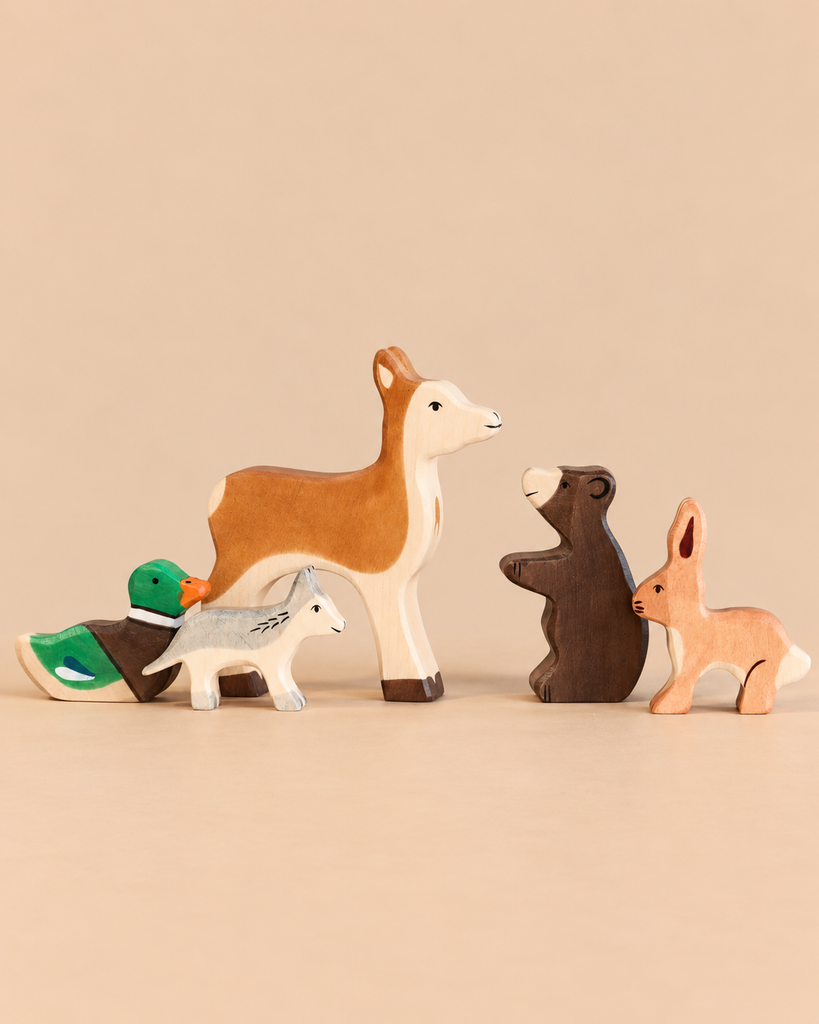 Holztiger Handmade Wooden Woodland Animals Set featuring five handcrafted wooden toys: a duck, a wolf, a deer, a bear, and a rabbit for imaginative play.