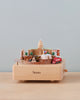 A Texas Wooden Music Box featuring cultural landmarks and icons of Texas, including the state capitol and a red truck, set against a plain background.