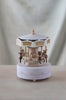 Six carousel hoses going around the music box and up and down as a soft melody plays in the background. 
