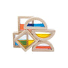 Sentence with product name: A set of five Wooden Water Blocks, each with a colorful translucent window in the center in shapes such as squares, triangles, and semicircles, stacked asymmetrically against a white background.