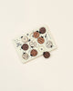 A Wooden Tray Puzzle - Count to 10 Ladybugs featuring various round animal faces and shapes in black, white, and natural wood colors on a soft beige background, crafted from sustainably sourced rubberwood.