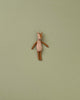 A small deer stuffed animal photographed on a flat background.